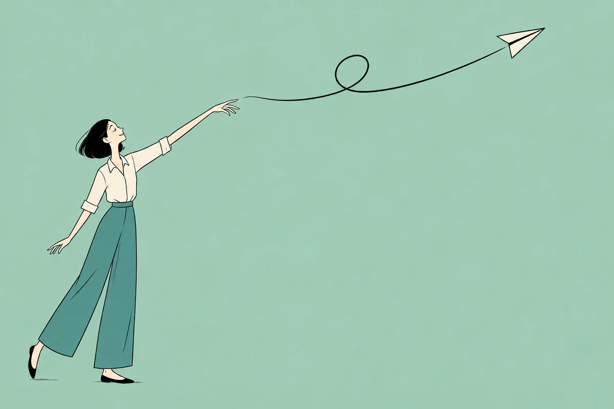 An adult woman sends a paper aeroplane across a soft sage background.