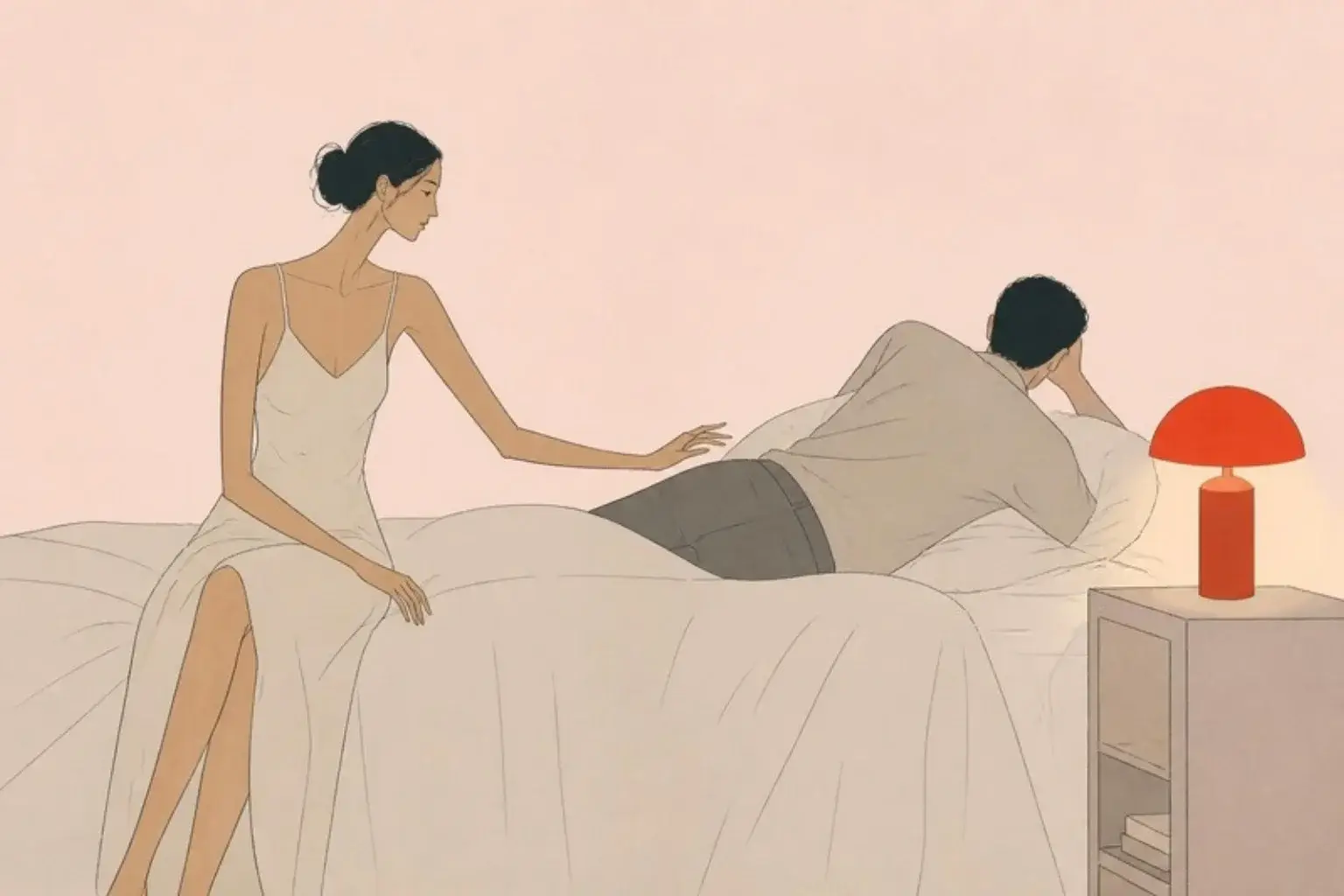 My husband does not want sex: a woman reaches towards her husband who lies turned away, a red lamp glowing